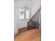 Wooden staircase with decorative iron railing, complemented by natural light from a nearby window at 301 Fortune St, Atlanta, GA 30312