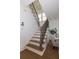 Elegant staircase featuring wood treads, decorative black iron spindles, and natural light at 301 Fortune St, Atlanta, GA 30312