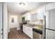 Bright kitchen with stainless appliances, granite countertops, and white cabinets at 3898 Rosedale Ln, Douglasville, GA 30135