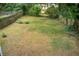 Spacious backyard features a large grassy area, mature trees, and a fenced perimeter at 198 Scott St Nw, Atlanta, GA 30314