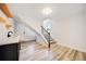 Bright basement features wood floors, a staircase, shelving and a modern sink with dark cabinets and marbled countertop at 198 Scott St Nw, Atlanta, GA 30314