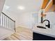 Bright basement features wood floors, a staircase, shelving and a modern sink with dark cabinets and marbled countertop at 198 Scott St Nw, Atlanta, GA 30314