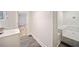 Modern bathroom featuring gray tile floors, white walls, a shower and a vanity at 198 Scott St Nw, Atlanta, GA 30314