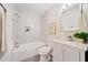 Updated bathroom featuring marble-look tile, a tub-shower combo, and a vanity with storage at 198 Scott St Nw, Atlanta, GA 30314