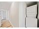 Hallway with stacked washer and dryer in a modern home at 198 Scott St Nw, Atlanta, GA 30314