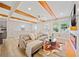 Bright living area with hardwood floors, wood beams, and open layout to the dining area at 198 Scott St Nw, Atlanta, GA 30314