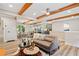 Open-concept living room with a modern design, wood beam ceiling, and a view into the kitchen at 198 Scott St Nw, Atlanta, GA 30314