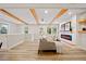 Sunlit living room with exposed beams, a modern fireplace, and open access to other rooms at 198 Scott St Nw, Atlanta, GA 30314