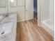 Bathroom featuring a double vanity with granite countertop, complemented by modern flooring at 2725 Saint Augustine Se Trl, Marietta, GA 30067