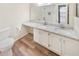 Bathroom featuring a double sink vanity, granite countertops, and a white tiled shower, combining style and functionality at 2725 Saint Augustine Se Trl, Marietta, GA 30067