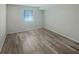 Clean, empty bedroom with wood floors and a window, offering a blank canvas for your personal touch and style at 2725 Saint Augustine Se Trl, Marietta, GA 30067