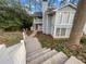 Inviting two-story condo with light blue siding, white trim, and a charming staircase leading to a private entrance at 2725 Saint Augustine Se Trl, Marietta, GA 30067