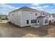 Spacious backyard with a concrete patio, level lawn, and neutral color palette on home's siding at 442 Payne Rd, Woodstock, GA 30188