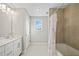 Bright bathroom features double sink vanity and tiled tub-shower combo with neutral walls at 442 Payne Rd, Woodstock, GA 30188