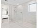 Modern bathroom featuring white tile, glass enclosed shower, and views into bedroom at 442 Payne Rd, Woodstock, GA 30188