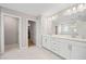 Bathroom with dual sinks, white cabinets and tile, and closet access at 442 Payne Rd, Woodstock, GA 30188