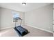 Bright bedroom featuring a treadmill by a window with neutral walls and carpet at 442 Payne Rd, Woodstock, GA 30188