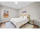 Cozy bedroom with a neutral color scheme, a large window, and minimalist decor at 442 Payne Rd, Woodstock, GA 30188