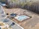 Resort-style pool and splash-pad surrounded by comfortable seating, lush landscaping, and mature trees at 442 Payne Rd, Woodstock, GA 30188