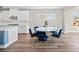 Dining area featuring modern blue chairs and a round white table, adjacent to the kitchen at 442 Payne Rd, Woodstock, GA 30188