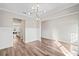 Dining room featuring hardwood floors, modern chandelier, and entry to the kitchen at 442 Payne Rd, Woodstock, GA 30188