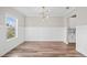 Bright dining room features modern light fixture, wainscoting, and hardwood floors at 442 Payne Rd, Woodstock, GA 30188