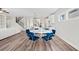 Open-concept dining area featuring a round table with blue velvet chairs, flowing into the kitchen at 442 Payne Rd, Woodstock, GA 30188