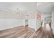 Open dining area with modern chandelier, hardwood floors, and access to kitchen and living spaces at 442 Payne Rd, Woodstock, GA 30188