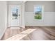 Bright entryway featuring wainscoting, hardwood floors, and natural light from the window and door at 442 Payne Rd, Woodstock, GA 30188