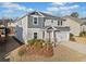 Two-story home with a gray exterior, two-car garage, and a well-maintained lawn at 442 Payne Rd, Woodstock, GA 30188