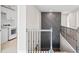 Upstairs hallway with decorative wall panel, iron railing, and laundry area at 442 Payne Rd, Woodstock, GA 30188