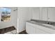 Bathroom featuring granite countertops, dual sinks, and a window for natural light at 608 Tudor St, Euharlee, GA 30145