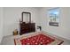 Bedroom featuring a decorative rug, a dresser with a mirror, and a window with lots of natural light at 608 Tudor St, Euharlee, GA 30145