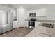 Modern kitchen with stainless steel appliances, granite countertops, and stylish white cabinetry at 608 Tudor St, Euharlee, GA 30145