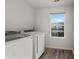 Clean laundry room featuring modern appliances and a window for ample natural light at 608 Tudor St, Euharlee, GA 30145