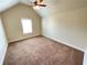 This bedroom features neutral walls, carpeted floors, ceiling fan, and a window at 61 Denton Ct, Acworth, GA 30101