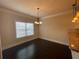 Cozy breakfast nook with a chandelier, hardwood floors, and a large window at 61 Denton Ct, Acworth, GA 30101