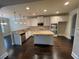 Spacious kitchen with an island, granite countertops, stainless steel appliances, and white cabinets at 61 Denton Ct, Acworth, GA 30101