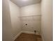 Cozy laundry room has tile floor, wire shelf, and hookups for washer and dryer at 61 Denton Ct, Acworth, GA 30101