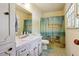 Bathroom featuring a single sink vanity, a beach-themed shower curtain, and a window for natural light at 1387 John Robert Dr, Morrow, GA 30260