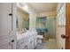 Clean bathroom with a vanity, a shower with beach themed curtain, and a neutral color scheme at 1387 John Robert Dr, Morrow, GA 30260