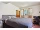 Bedroom featuring neutral walls, a cozy bed with a gray comforter, and a functional workspace at 1387 John Robert Dr, Morrow, GA 30260