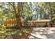 Charming two-story brick home with a covered carport and mature trees in a leafy neighborhood at 1387 John Robert Dr, Morrow, GA 30260