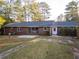 Back of house shows brick exterior and large sliding glass doors that lead to a spacious backyard with a patio at 4149 Indian Lake Cir, Stone Mountain, GA 30083