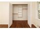 Open closet features shelving and hardwood floors at 4149 Indian Lake Cir, Stone Mountain, GA 30083