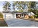 Charming single-story brick home boasts a two car garage and large driveway at 4149 Indian Lake Cir, Stone Mountain, GA 30083