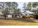 Charming single-story home with brick accents and a well-maintained front lawn in a wooded setting at 4149 Indian Lake Cir, Stone Mountain, GA 30083