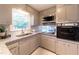 Traditional kitchen featuring granite counters, stainless steel appliances, and abundant natural light at 4149 Indian Lake Cir, Stone Mountain, GA 30083