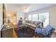 Bright living room featuring large windows, hardwood floors, and stylish contemporary furniture at 4149 Indian Lake Cir, Stone Mountain, GA 30083