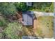 Aerial view of the house highlighting its backyard, mature trees and roof at 629 Granite Ln, Loganville, GA 30052